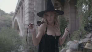 Сексуальная ведьма раздевается возле каменного замка